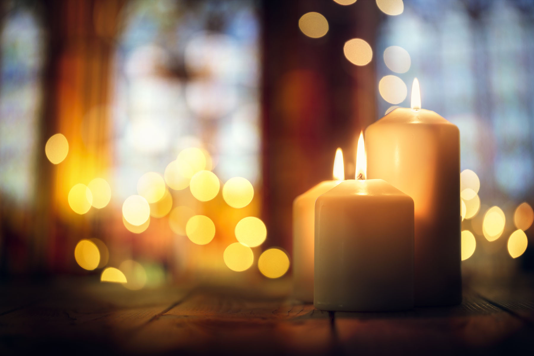 Candles burning in a church background